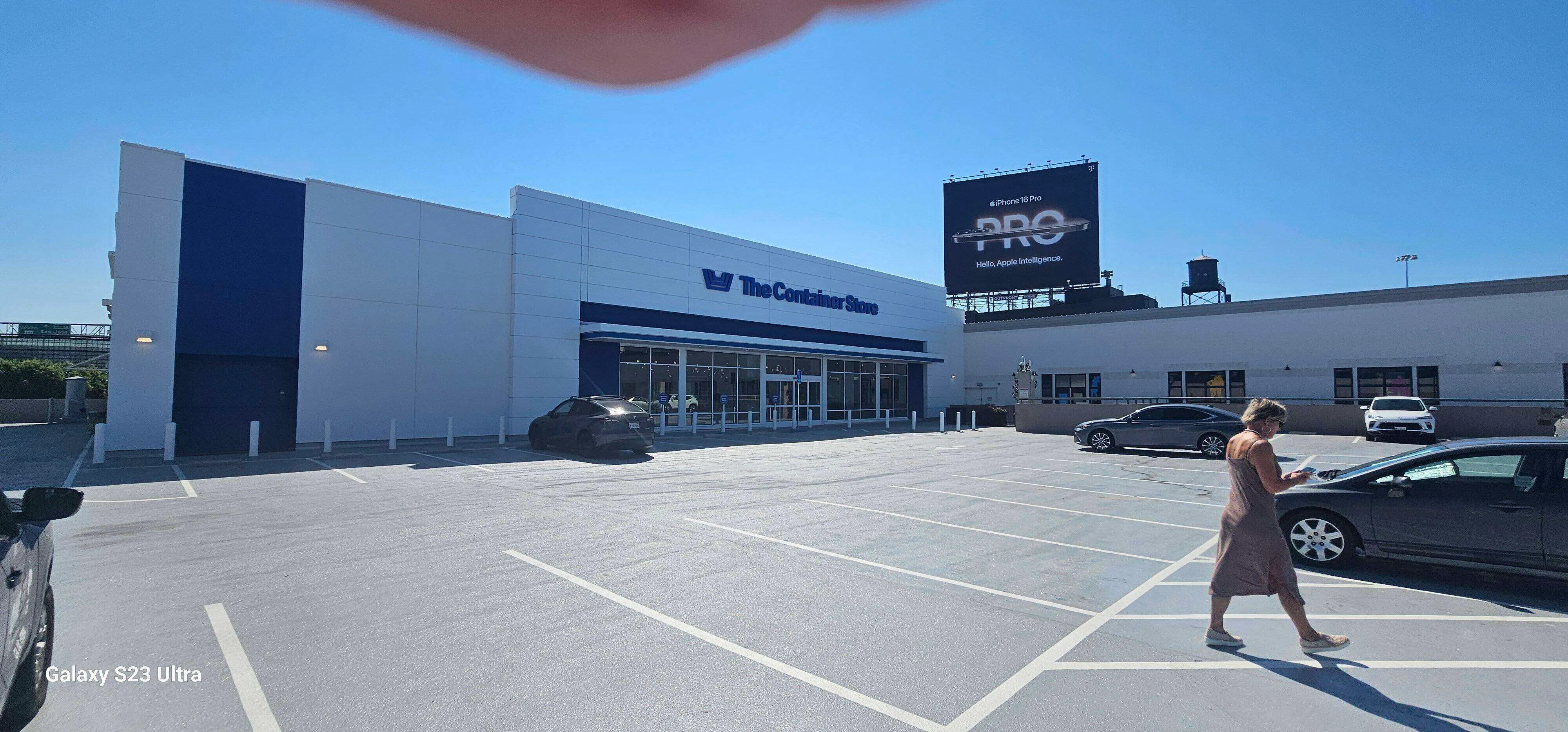 Exterior view of The Container Store with EIFS facade and parking lot.