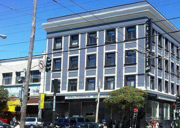 Multi-story commercial building with stucco facade and decorative trim in San Francisco.